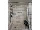 Bathroom shower featuring elegant gray and white marble tiling, a shower bench and a shower caddy at 19029 Us Highway 19 N # 12E, Clearwater, FL 33764