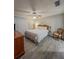 Carpetless bedroom featuring a ceiling fan, stylish decor, and plentiful natural light at 19029 Us Highway 19 N # 12E, Clearwater, FL 33764