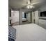 Bedroom featuring a white bedspread, wood-look floors, and mirrored closet at 19029 Us Highway 19 N # 12E, Clearwater, FL 33764