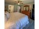 Spacious bedroom featuring an ensuite bathroom and an assortment of wooden furniture at 19029 Us Highway 19 N # 12E, Clearwater, FL 33764