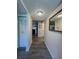 Hallway with luxury vinyl plank flooring and access to the front door at 19029 Us Highway 19 N # 12E, Clearwater, FL 33764