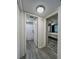 Hallway with access to a bathroom and bedroom, featuring wood-look floors at 19029 Us Highway 19 N # 12E, Clearwater, FL 33764