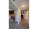 Open kitchen view featuring white appliances and laminate floors at 19029 Us Highway 19 N # 12E, Clearwater, FL 33764