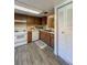 Charming kitchen featuring white appliances, wood cabinets, and tile backsplash at 19029 Us Highway 19 N # 12E, Clearwater, FL 33764