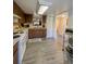 Spacious kitchen featuring white appliances, wood cabinets, and laminate floors at 19029 Us Highway 19 N # 12E, Clearwater, FL 33764
