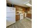 Well-lit kitchen featuring white appliances, wood cabinets, and ample counter space at 19029 Us Highway 19 N # 12E, Clearwater, FL 33764