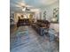 Open living room featuring wood-look floors, sofas, and decorative wall art at 19029 Us Highway 19 N # 12E, Clearwater, FL 33764