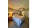 Cozy main bedroom with a ceiling fan, ensuite bathroom, and spacious closet at 19029 Us Highway 19 N # 12E, Clearwater, FL 33764