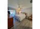 Light-filled main bedroom features a ceiling fan and sliding door access to an outdoor living space at 19029 Us Highway 19 N # 12E, Clearwater, FL 33764