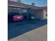 Cars parked under a shaded parking area, next to an exterior storage closet in the parking area at 19029 Us Highway 19 N # 12E, Clearwater, FL 33764