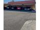 Parking space area including 5 cars parked under a low roof with a concrete ground area at 19029 Us Highway 19 N # 12E, Clearwater, FL 33764