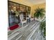 Enclosed patio area with tile flooring, ceiling fan, and casual seating area at 19029 Us Highway 19 N # 12E, Clearwater, FL 33764