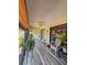 Enclosed patio area with tile flooring, ceiling fan, and casual seating area at 19029 Us Highway 19 N # 12E, Clearwater, FL 33764