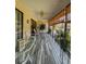 Enclosed patio area with tile flooring, ceiling fan, and casual seating area at 19029 Us Highway 19 N # 12E, Clearwater, FL 33764
