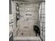 Beautifully tiled walk-in shower featuring modern fixtures and a convenient bench at 19029 Us Highway 19 N # 12E, Clearwater, FL 33764