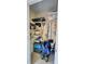Overstuffed storage closet with an assortment of household items, tools, and cleaning equipment at 19029 Us Highway 19 N # 12E, Clearwater, FL 33764