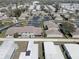 Community aerial showcasing residences, palm trees, parking, roads, and nearby green spaces in a well-organized neighborhood layout at 2131 Ridge S Rd # 132, Largo, FL 33778