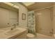 Clean bathroom featuring a tub/shower combo with floral curtain and ample counter space at 2131 Ridge S Rd # 132, Largo, FL 33778