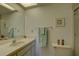 Well-lit bathroom features a sink vanity, toilet, framed art and walk-in shower at 2131 Ridge S Rd # 132, Largo, FL 33778