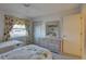 Cozy bedroom with two twin beds, dresser, and a window with patterned curtains at 2131 Ridge S Rd # 132, Largo, FL 33778