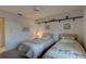 Comfortable bedroom with twin beds, soft carpet, and decorative wall shelf at 2131 Ridge S Rd # 132, Largo, FL 33778