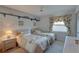 Bright bedroom featuring two twin beds, ceiling fan, and tropical-themed decor at 2131 Ridge S Rd # 132, Largo, FL 33778