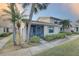 Inviting home exterior featuring lush landscaping and a screened-in porch at 2131 Ridge S Rd # 132, Largo, FL 33778