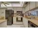 Functional kitchen design with appliances and a pass-through to the living area, offering a connected living experience at 2131 Ridge S Rd # 132, Largo, FL 33778