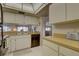 Kitchen area featuring tile floors, a stainless steel sink, dishwasher and countertop appliances at 2131 Ridge S Rd # 132, Largo, FL 33778