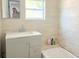 Bathroom features a vanity with a sink and a tub with tiled walls at 2410 Harper St, Tampa, FL 33605
