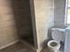 Bathroom features toilet, shower, and tiled walls at 2410 Harper St, Tampa, FL 33605