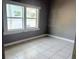 Bedroom featuring tile flooring and a window at 2410 Harper St, Tampa, FL 33605