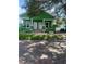 Charming green home with brick pillars and a cozy front porch at 2410 Harper St, Tampa, FL 33605