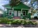 Charming green home with brick pillars and a cozy front porch at 2410 Harper St, Tampa, FL 33605