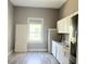 Kitchen with white cabinets, a sink, and space for dining at 2410 Harper St, Tampa, FL 33605
