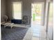 Cozy living room featuring an area rug, window, and doorway leading outside at 2410 Harper St, Tampa, FL 33605