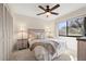 Cozy bedroom with a ceiling fan, neutral carpet and a large window for plenty of natural light at 2576 Laurelwood Dr # 13C, Clearwater, FL 33763