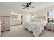 Cozy bedroom features an ensuite bathroom, natural light and neutral decor at 2576 Laurelwood Dr # 13C, Clearwater, FL 33763