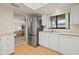 Bright kitchen with stainless steel refrigerator, white cabinetry, and sleek flooring at 2576 Laurelwood Dr # 13C, Clearwater, FL 33763