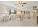 Bright living room featuring a ceiling fan, a large window and a mirror wall for enhanced spaciousness at 2576 Laurelwood Dr # 13C, Clearwater, FL 33763
