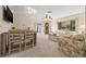 Inviting living room featuring a ceiling fan, carpeted floors, and ample natural light at 2576 Laurelwood Dr # 13C, Clearwater, FL 33763