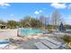 Community pool features lounge chairs and tables for relaxing by the water at 2576 Laurelwood Dr # 13C, Clearwater, FL 33763