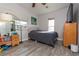 Cozy bedroom with grey wood flooring and bright natural light at 313 Jefferson S Ave, Oldsmar, FL 34677