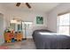 Cozy bedroom with grey wood flooring and bright natural light at 313 Jefferson S Ave, Oldsmar, FL 34677