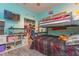 Bright bedroom features a bunk bed, organized closet, and a mounted television at 313 Jefferson S Ave, Oldsmar, FL 34677