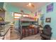Bedroom with bunkbed, grey wood flooring, wall decor, and natural light from two windows at 313 Jefferson S Ave, Oldsmar, FL 34677