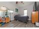 Cozy bedroom with grey wood flooring and bright natural light at 313 Jefferson S Ave, Oldsmar, FL 34677