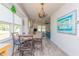 Bright dining area with a marble table and lovely pendant lighting adjacent to the living area at 313 Jefferson S Ave, Oldsmar, FL 34677