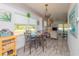 Bright dining area with a marble table and lovely pendant lighting adjacent to the living area at 313 Jefferson S Ave, Oldsmar, FL 34677