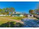 Single-story home with a sunny front yard and detached shed at 313 Jefferson S Ave, Oldsmar, FL 34677
